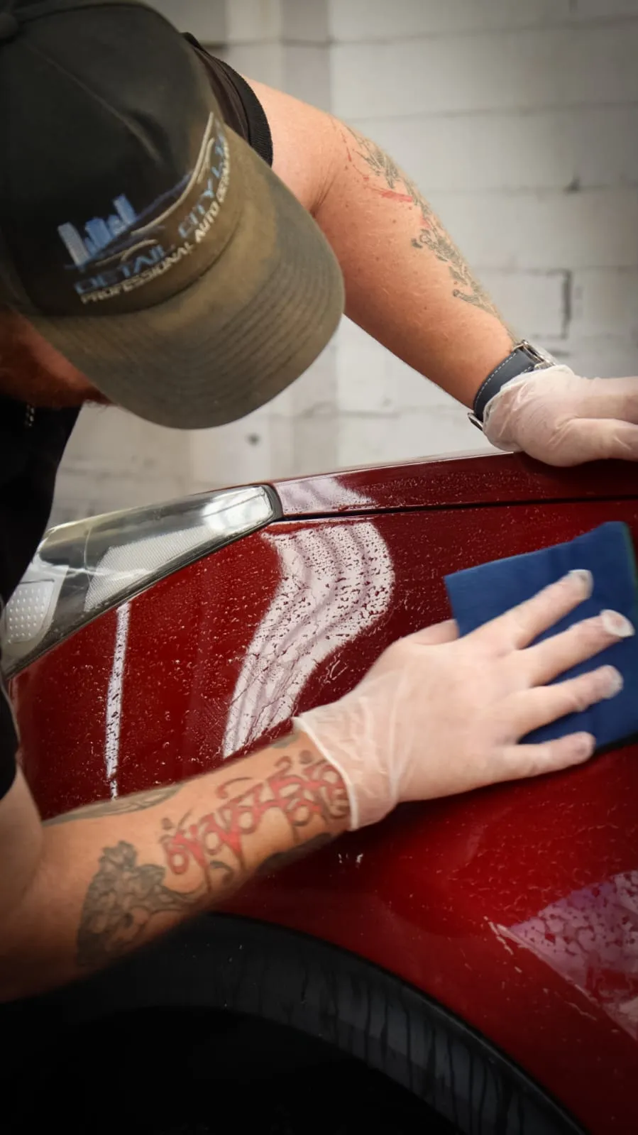 Detail City Ltd — hand detailing and paint decontamination on a red car in Levin